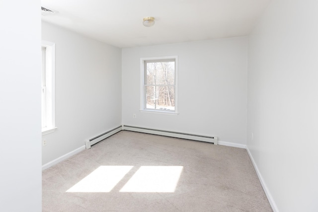 unfurnished room with baseboard heating, baseboards, and carpet