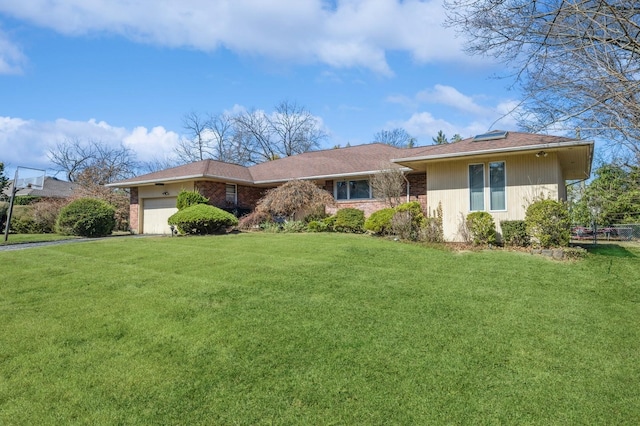 single story home featuring brick siding, an attached garage, driveway, and a front lawn