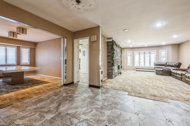 interior space with recessed lighting, visible vents, baseboards, and radiator heating unit