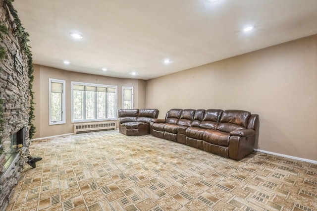 living area with recessed lighting, radiator, a fireplace, and baseboards