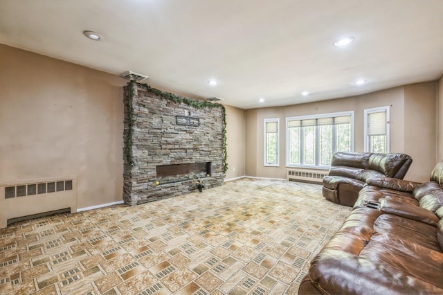 living room with recessed lighting, radiator, a fireplace, and visible vents