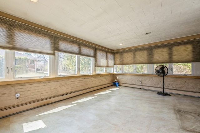 unfurnished sunroom with a baseboard heating unit