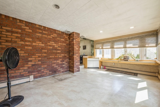 interior space with baseboard heating, recessed lighting, brick wall, and concrete flooring