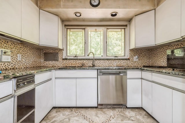 kitchen featuring a sink, backsplash, dishwasher, and white cabinets