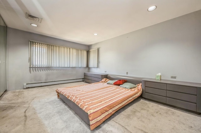 carpeted bedroom with recessed lighting, visible vents, and a baseboard heating unit