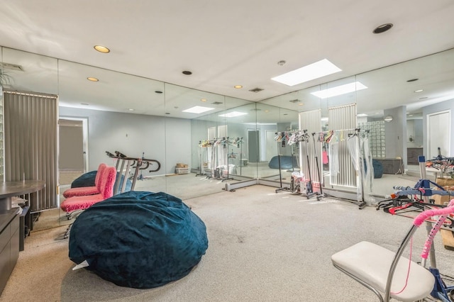 workout area with visible vents, a skylight, and carpet