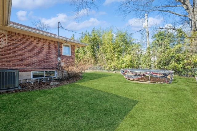 view of yard featuring central air condition unit