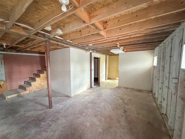 unfinished basement featuring stairs