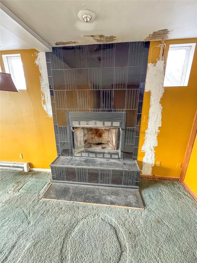 details with a tile fireplace, baseboards, and carpet floors