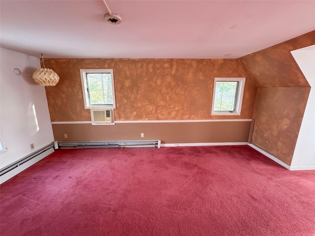 additional living space with a wall mounted air conditioner, a baseboard heating unit, plenty of natural light, and carpet floors