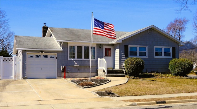 view of front of house with fence, an attached garage, a chimney, a shingled roof, and concrete driveway