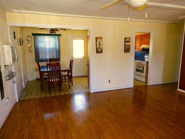 dining space with wood finished floors, crown molding, and a ceiling fan