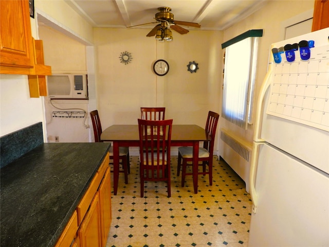 dining room with radiator, a ceiling fan, light floors, and a wall mounted AC