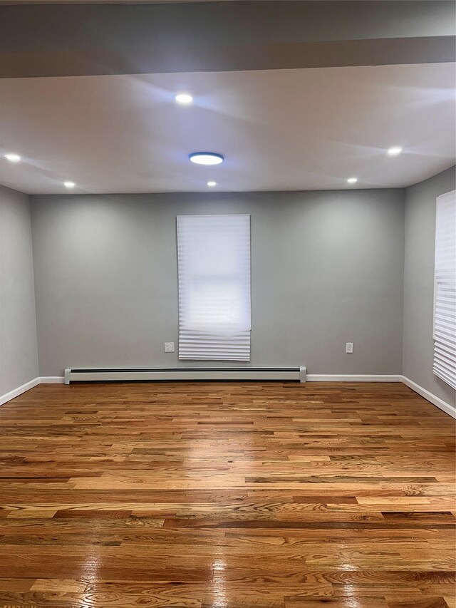 223-45 113th Dr, Queens Village, NY 11429 - empty room with wood finished floors, a baseboard heating unit, and recessed lighting