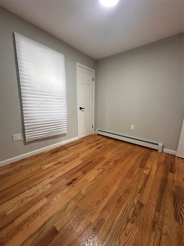 223-45 113th Dr, Queens Village, NY 11429 - spare room with baseboard heating and wood finished floors