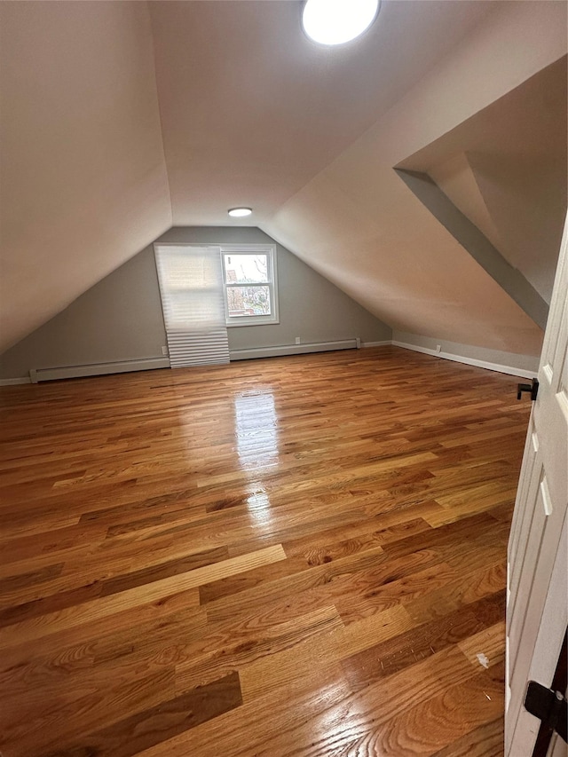 223-45 113th Dr, Queens Village, NY 11429 - additional living space featuring baseboard heating, lofted ceiling, and wood finished floors