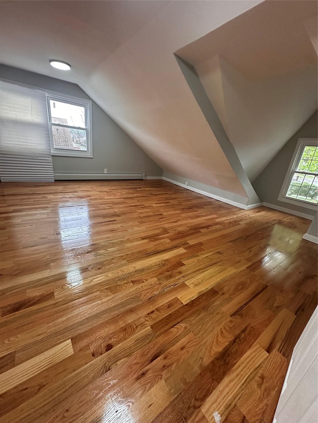 223-45 113th Dr, Queens Village, NY 11429 - additional living space featuring vaulted ceiling, wood finished floors, and baseboard heating
