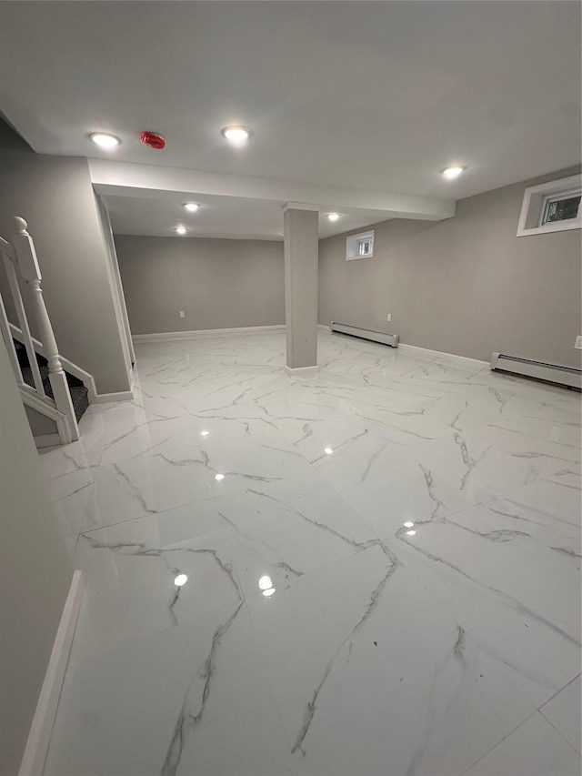 223-45 113th Dr, Queens Village, NY 11429 - finished below grade area with a baseboard radiator, light marble finish floors, and recessed lighting