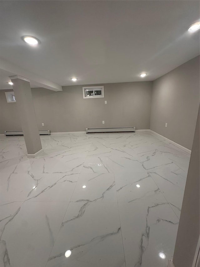 223-45 113th Dr, Queens Village, NY 11429 - finished basement featuring a baseboard heating unit, light marble finish flooring, and baseboard heating
