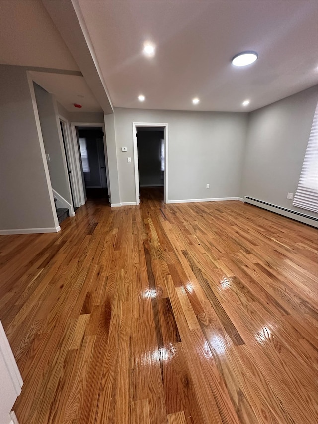 223-45 113th Dr, Queens Village, NY 11429 - unfurnished living room featuring a baseboard radiator, wood finished floors, stairway, and recessed lighting
