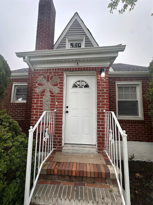 223-45 113th Dr, Queens Village, NY 11429 - property entrance with brick siding and a chimney