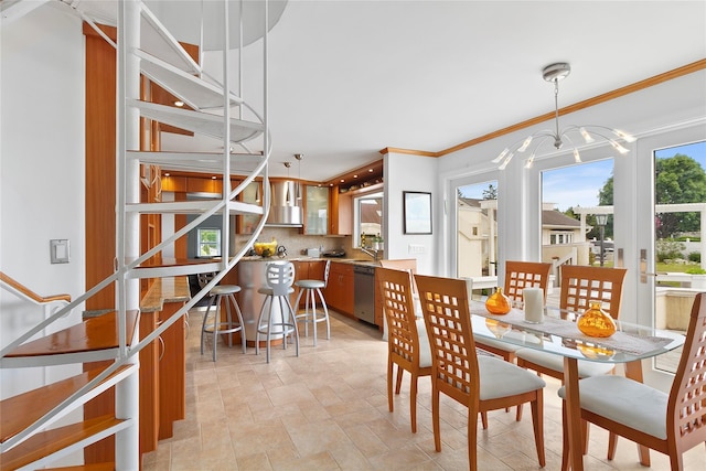 dining area with stone finish flooring, ornamental molding, stairs, and a chandelier