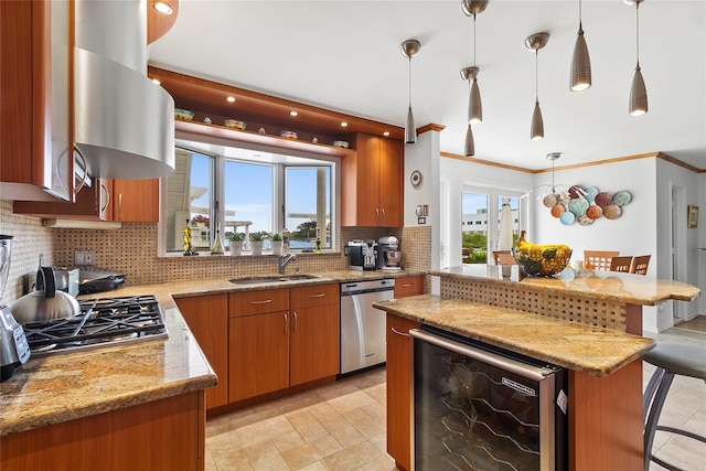 kitchen featuring brown cabinets, a sink, wine cooler, appliances with stainless steel finishes, and light stone countertops