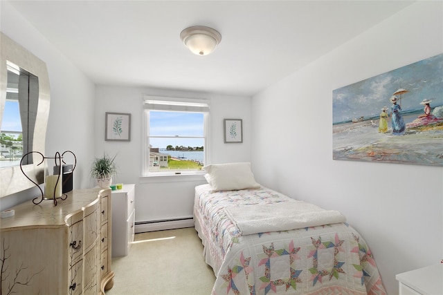 bedroom featuring multiple windows, baseboard heating, and light carpet