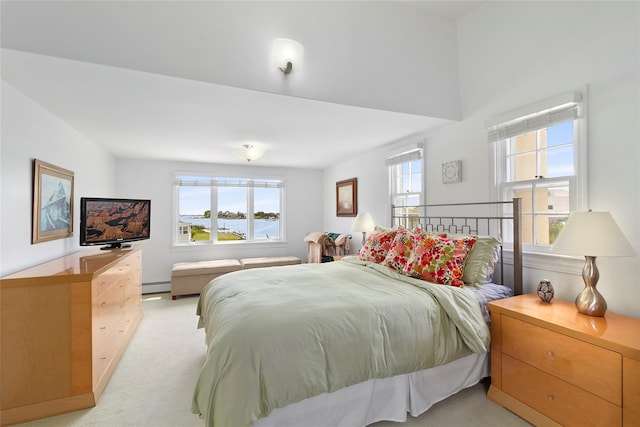 bedroom featuring a baseboard heating unit and light carpet