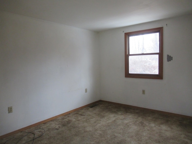 spare room with carpet flooring and baseboards