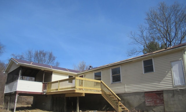 rear view of property with a deck and stairway