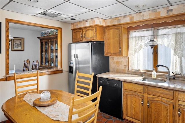 kitchen featuring visible vents, stainless steel fridge with ice dispenser, a sink, dishwasher, and brown cabinets