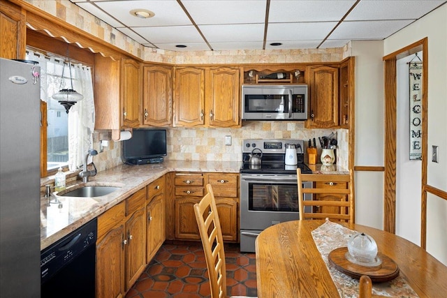 kitchen featuring a sink, brown cabinetry, tasteful backsplash, and stainless steel appliances