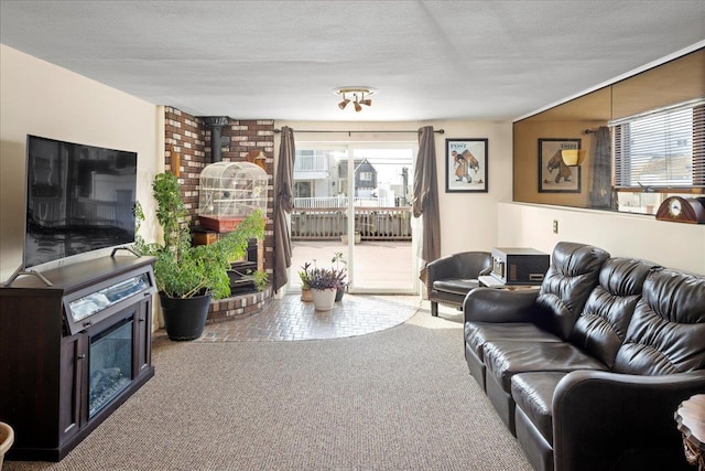 living area with a wealth of natural light, carpet flooring, a textured ceiling, and a wood stove