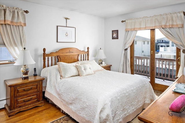 bedroom featuring access to outside and light wood-style flooring