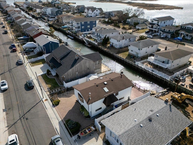 drone / aerial view featuring a residential view and a water view