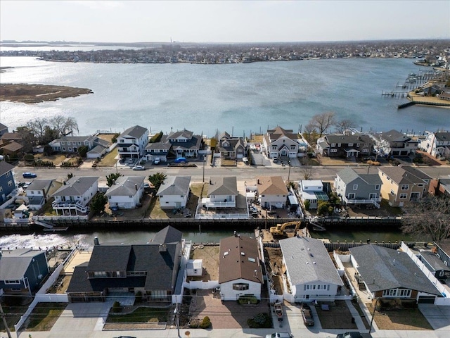 drone / aerial view with a residential view and a water view