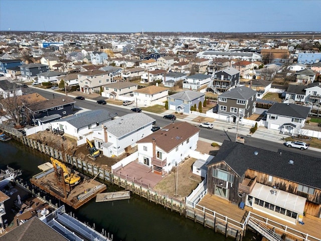 drone / aerial view featuring a residential view and a water view