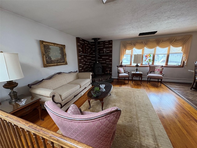 502 Nassau Ave, Freeport, NY 11520 - living area featuring baseboards, a textured ceiling, wood finished floors, and a wood stove