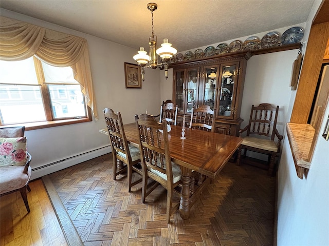 502 Nassau Ave, Freeport, NY 11520 - dining area with a baseboard heating unit, a textured ceiling, and a chandelier