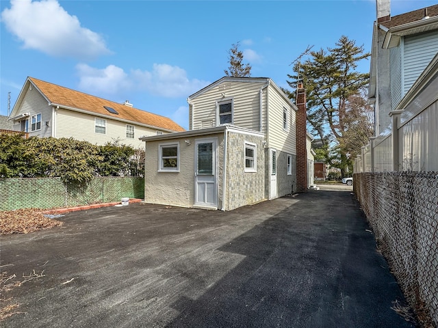 rear view of house with fence