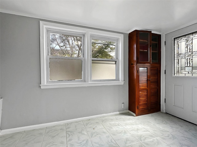 doorway to outside with marble finish floor and baseboards