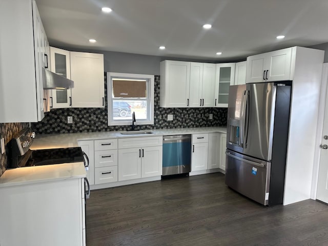 kitchen featuring a sink, glass insert cabinets, appliances with stainless steel finishes, and dark wood finished floors