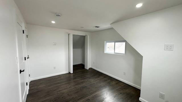 12 Meridian Rd, Levittown, NY 11756 - unfurnished bedroom featuring dark wood-style floors, visible vents, baseboards, recessed lighting, and a closet