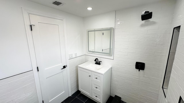 12 Meridian Rd, Levittown, NY 11756 - bathroom featuring visible vents, recessed lighting, tile walls, tile patterned flooring, and vanity