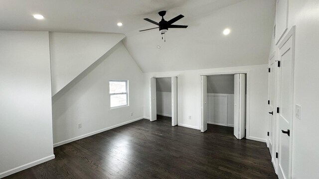 12 Meridian Rd, Levittown, NY 11756 - unfurnished bedroom with baseboards, multiple closets, dark wood-type flooring, and lofted ceiling