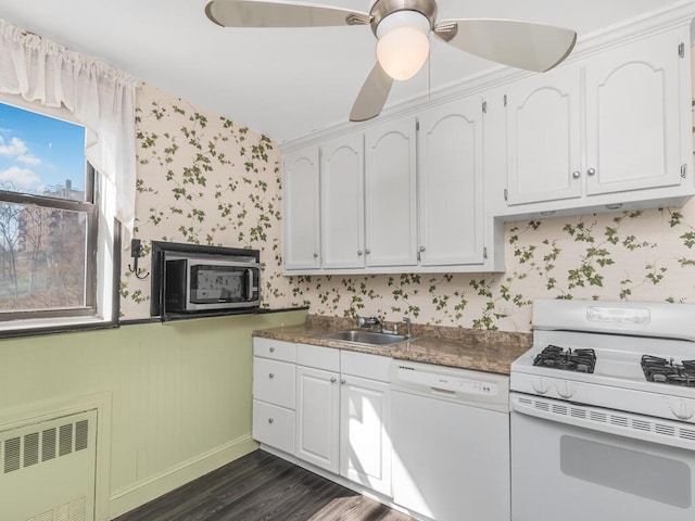 kitchen featuring white cabinetry, white appliances, wallpapered walls, and radiator heating unit