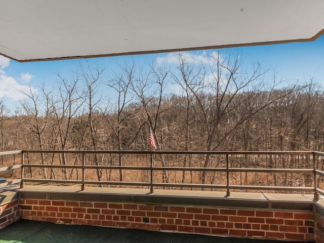 balcony featuring a forest view