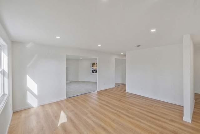 spare room with recessed lighting, baseboards, and light wood-style flooring