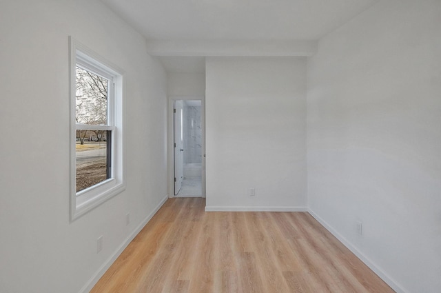 spare room with light wood-type flooring and baseboards